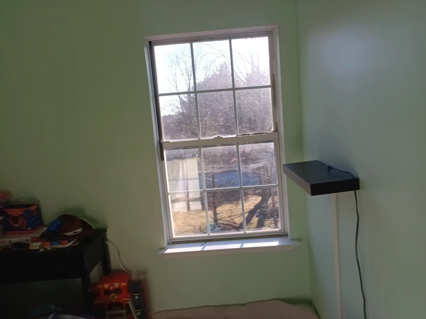 Interior view of an old window in Janice and Richard T.’s home prior to its replacement